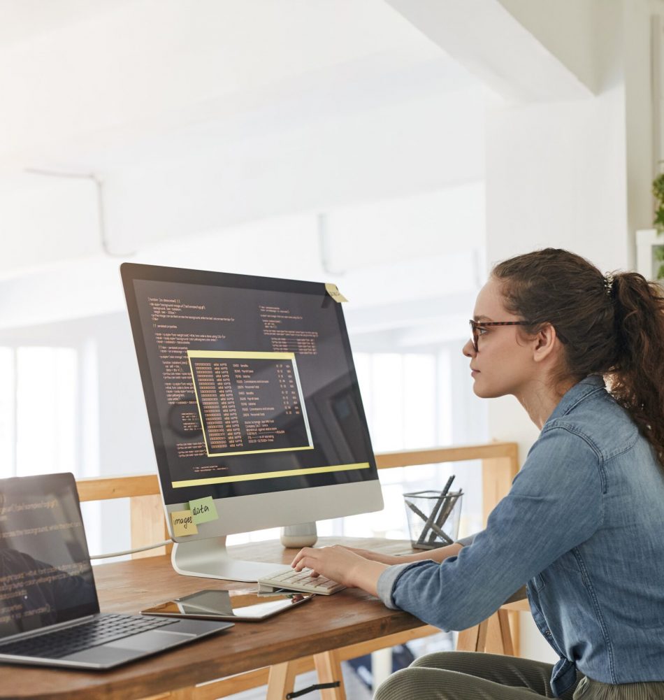 side-view-portrait-female-it-developer-typing-keyboard-with-black-orange-programming-code-computer-screen-laptop-contemporary-office-interior-copy-space (1) side-view-portrait-female-it-developer-typing-keyboard-with-black-orange-programming-code-computer-screen-laptop-contemporary-office-interior-copy-space (1)